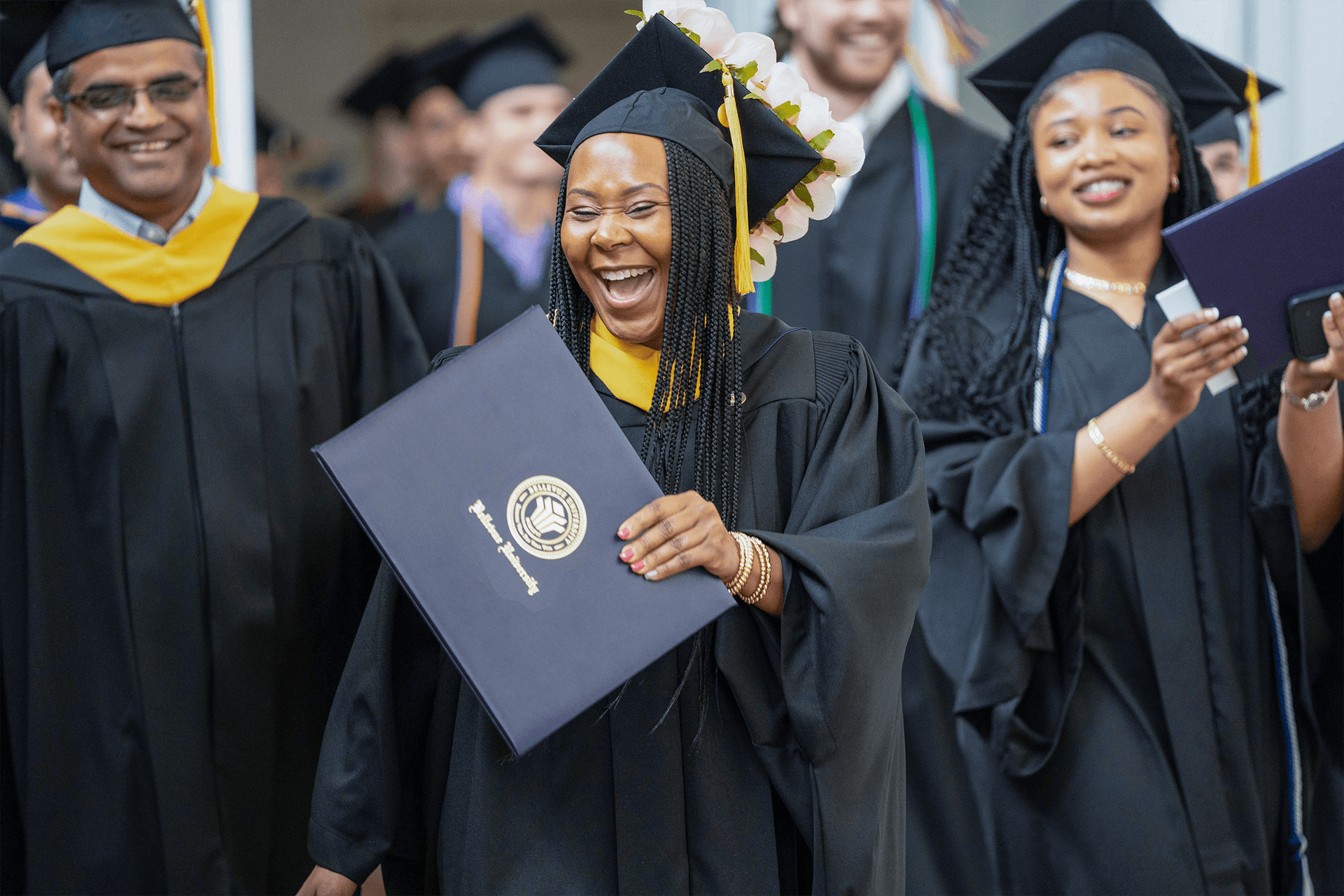 BU Graduate smiling in crowd