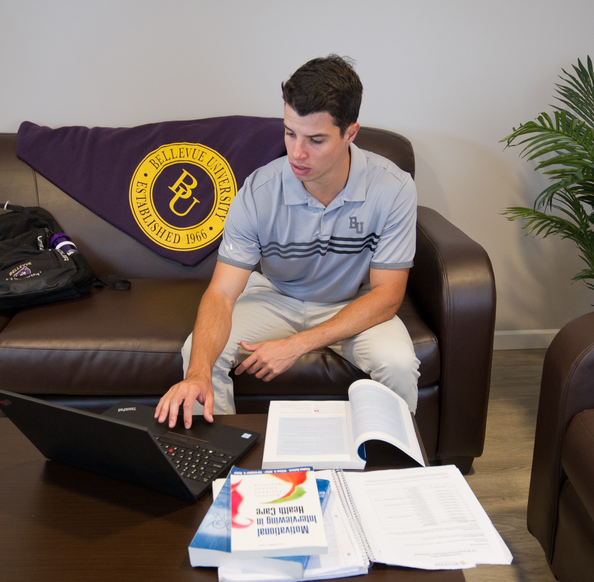 student on laptop in dorm